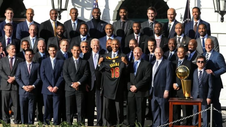 Nov 10, 2016; Washington, DC, USA; President Barack Obama (M) poses holding a gift jersey with Vice President Joe Biden (M-L) and members of the Cleveland Cavaliers at an event honoring the 2016 NBA world champion Cavaliers on the South Lawn at the White House. Mandatory Credit: Geoff Burke-USA TODAY NETWORK