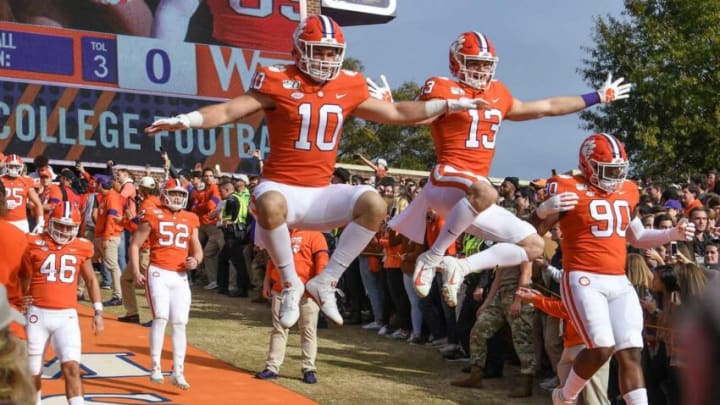 Clemson linebacker Baylon Spector (10) and wide receiver Brannon Spector (13) leap down the hill together before a game last season.Clemson Vs Wake