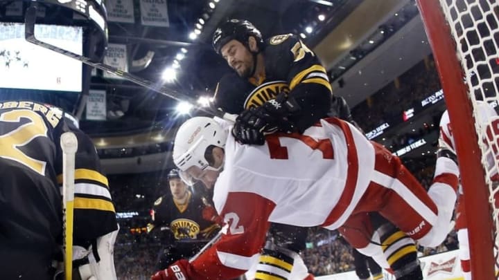 Mar 8, 2015; Boston, MA, USA; Boston Bruins defenseman Adam McQuaid (54) knocks down Detroit Red Wings right wing Erik Cole (72) in the crease during the third period of the Boston Bruins 5-3 win over the Detroit Red Wings at TD Garden. Mandatory Credit: Winslow Townson-USA TODAY Sports
