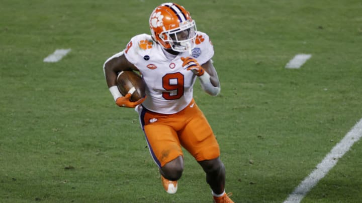 CHARLOTTE, NORTH CAROLINA - DECEMBER 19: Running back Travis Etienne #9 of the Clemson Tigers runs with the ball on a kickoff return in the second half against the Notre Dame Fighting Irish during the ACC Championship game at Bank of America Stadium on December 19, 2020 in Charlotte, North Carolina. (Photo by Jared C. Tilton/Getty Images)