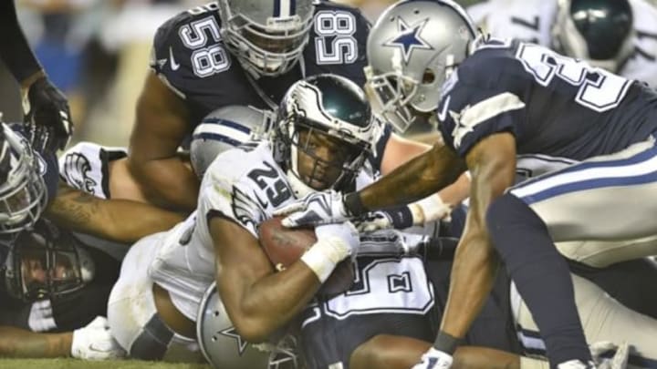 Sep 20, 2015; Philadelphia, PA, USA; Philadelphia Eagles running back DeMarco Murray looks at the line judge as Dallas Cowboys defensive tackle Jack Crawford tackles him in the fourth quarter at Lincoln Financial Field. Mandatory Credit: James Lang-USA TODAY Sports