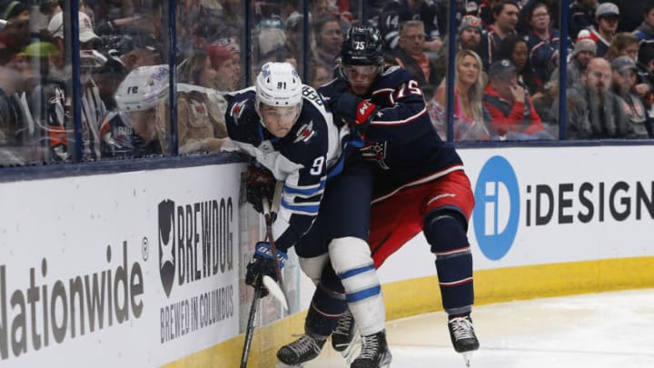 Feb 16, 2023; Columbus, Ohio, USA; Columbus Blue Jackets defenseman Tim Berni (75) checks Winnipeg Jets center Cole Perfetti (91) off the puck during the third period at Nationwide Arena. Mandatory Credit: Russell LaBounty-USA TODAY Sports