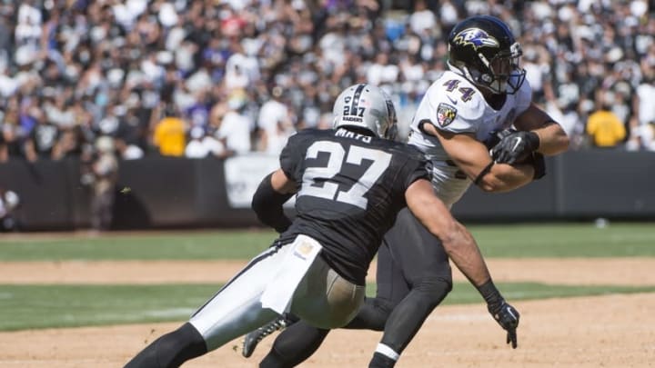 September 20, 2015; Oakland, CA, USA; Baltimore Ravens fullback Kyle Juszczyk (44) runs with the football against Oakland Raiders defensive back Taylor Mays (27) during the second quarter at O.co Coliseum. Mandatory Credit: Kyle Terada-USA TODAY Sports