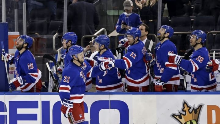 Apr 5, 2016; New York, NY, USA; New York Rangers center Derek Stepan (21) celebrates scoring a goal with teammates during the third period against the Tampa Bay Lightning at Madison Square Garden. The Rangers defeated the Lightning 3-2. Mandatory Credit: Adam Hunger-USA TODAY Sports