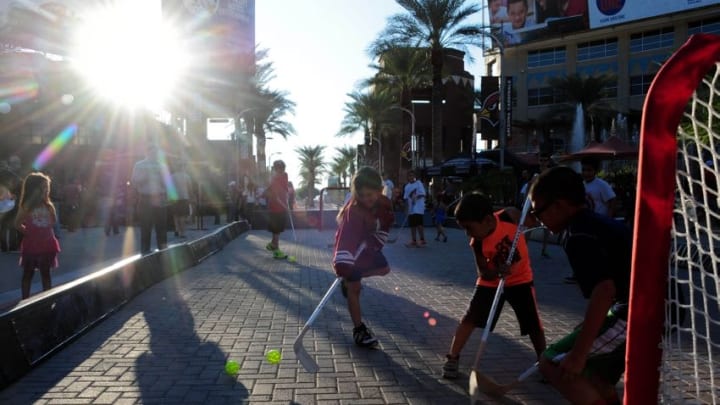 Oct 9, 2014; Glendale, AZ, USA; Young fans play street hockey prior to the game between the Arizona Coyotes and the Winnipeg Jets at Gila River Arena. Mandatory Credit: Matt Kartozian-USA TODAY Sports