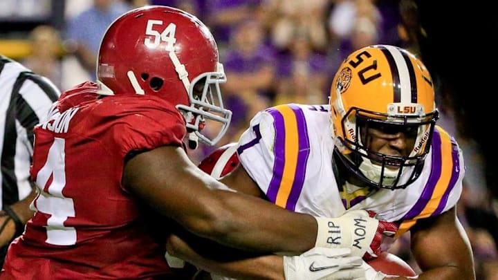 Nov 5, 2016; Baton Rouge, LA, USA; LSU Tigers running back Leonard Fournette (7) is tackled by Alabama Crimson Tide defensive lineman Dalvin Tomlinson (54) during the third quarter of a game at Tiger Stadium. Alabama defeated LSU 10-0. Mandatory Credit: Derick E. Hingle-USA TODAY Sports