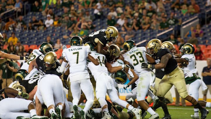 DENVER, CO - SEPTEMBER 2: Running back Kyle Evans #21 of the Colorado Buffaloes leaps over the pile for a goal line rushing touchdown against the Colorado State Rams at Sports Authority Field at Mile High on September 2, 2016 in Denver, Colorado. (Photo by Dustin Bradford/Getty Images)