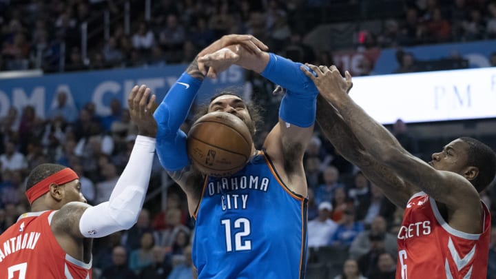 OKLAHOMA CITY, OK – NOVEMBER 8: Carmelo Anthony #7 of the Houston Rockets and Gary Clark #6 of the Houston Rockets block Steven Adams #12 of the Oklahoma City Thunder from shooting two points during the first half of a NBA game at the Chesapeake Energy Arena on November 8, 2018 in Oklahoma City, Oklahoma. NOTE TO USER: User expressly acknowledges and agrees that, by downloading and or using this photograph, User is consenting to the terms and conditions of the Getty Images License Agreement. (Photo by J Pat Carter/Getty Images)