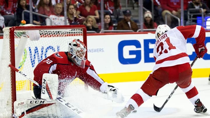 WASHINGTON, DC - FEBRUARY 11: Detroit Red Wings left wing Tomas Tatar (21) beats Washington Capitals goaltender Braden Holtby (70) for the winning goal in overtime during a NHL game between the Washington Capitals and the Detroit Red Wings on February 11, 2018, at Capital One Arena, in Washington, D.C. Detroit defeated Washington 5-4 in overtime.(Photo by Tony Quinn/Icon Sportswire via Getty Images)