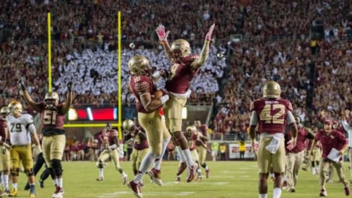 Oct 18, 2014; Tallahassee, FL, USA; Florida State Seminoles linebacker Jacob Pugh (16) celebrates with running back Karlos Williams (9) after an interception in the fourth quarter against the Notre Dame Fighting Irish at Doak Campbell Stadium. Florida State won 31-27. Mandatory Credit: Matt Cashore-USA TODAY Sports Oct 18, 2014; Tallahassee, FL, USA; Florida State Seminoles linebacker Jacob Pugh (16) celebrates with running back Karlos Williams (9) after an interception in the fourth quarter against the Notre Dame Fighting Irish at Doak Campbell Stadium. Florida State won 31-27. Mandatory Credit: Matt Cashore-USA TODAY Sports