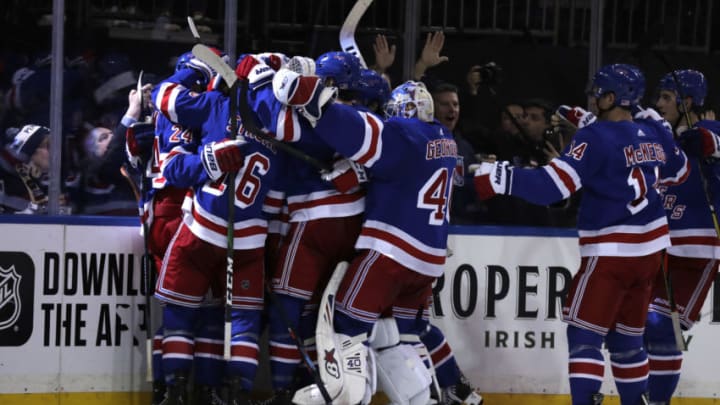 Nov 12, 2019; New York, NY, USA; New York Rangers right wing Kaapo Kakko (24) is congratulated by teammates after scoring the game winning goal against the Pittsburgh Penguins during overtime at Madison Square Garden. Mandatory Credit: Adam Hunger-USA TODAY Sports