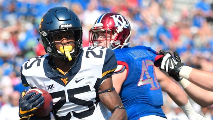 LAWRENCE, KS - SEPTEMBER 23: Justin Crawford #25 of the West Virginia Mountaineers runs for a touchdown past Keith Loneker Jr. #47 of the Kansas Jayhawks in the second quarter at Memorial Stadium on September 23, 2017 in Lawrence, Kansas. (Photo by Ed Zurga/Getty Images)