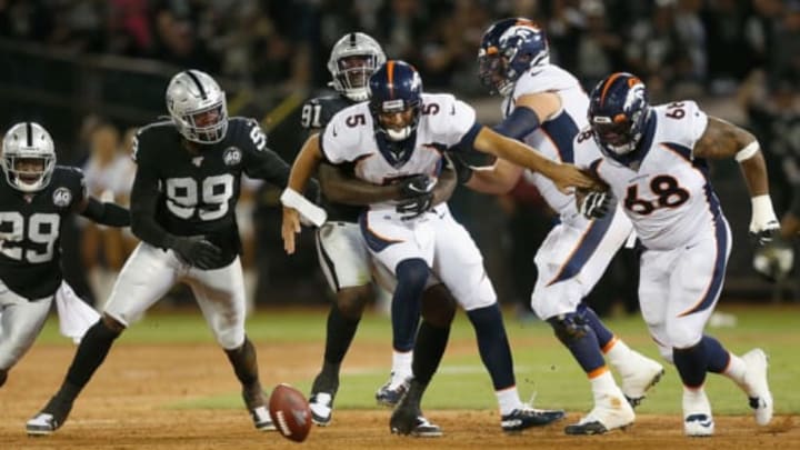 OAKLAND, CALIFORNIA – SEPTEMBER 09: Quarterback Joe Flacco #5 of the Denver Broncos is stripped of the ball by the Oakland Raiders defense in the second quarter of the game at RingCentral Coliseum on September 09, 2019 in Oakland, California. Oakland Raiders (Photo by Lachlan Cunningham/Getty Images)