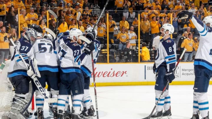 NASHVILLE, TN - MAY 10: Connor Hellebuyck #37 of the Winnipeg Jets is congratulated by teammates after a 5-1 win in Game Seven of the Western Conference Second Round during the 2018 NHL Stanley Cup Playoffs at Bridgestone Arena on May 10, 2018 in Nashville, Tennessee. (Photo by John Russell/NHLI via Getty Images)