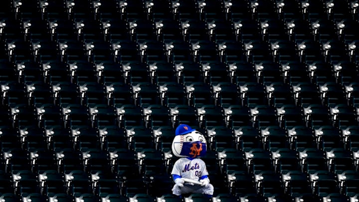 NEW YORK, NEW YORK - AUGUST 12: Mr. Met sits amongst empty seats with a mask on during the game between the New York Mets and the Washington Nationals at Citi Field on August 12, 2020 in New York City. Due to concerns of the spread of the coronavirus, MLB games are being played without fans. (Photo by Steven Ryan/Getty Images)