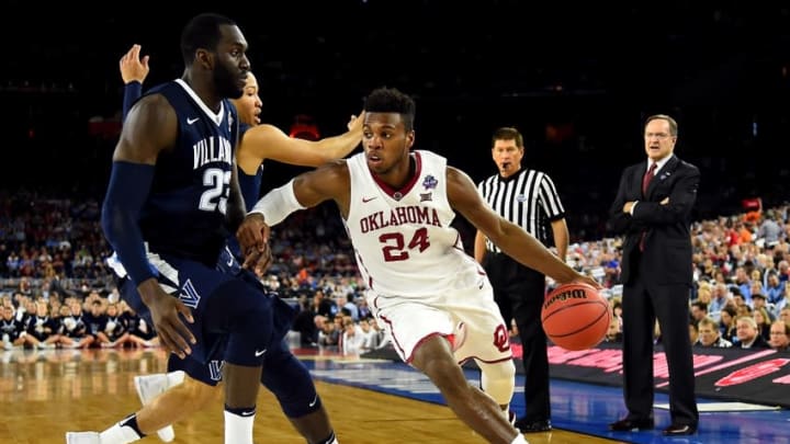 Apr 2, 2016; Houston, TX, USA; Oklahoma Sooners guard Buddy Hield (24) drives to the basket against Villanova Wildcats forward Daniel Ochefu (23) during the second half in the 2016 NCAA Men