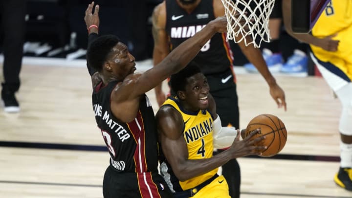 Victor Oladipo (4) drives past Miami Heat's Bam Adebayo (Ashley Landis/Pool Photo-USA TODAY Sports)