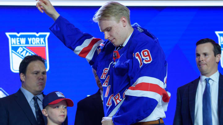 VANCOUVER, BC – JUNE 21: Kaapo Kakko puts on a jersey after being selected second overall by the New York Rangers during the first round of the 2019 NHL Draft at Rogers Arena on June 21, 2019 in Vancouver, British Columbia, Canada. (Photo by Derek Cain/Icon Sportswire via Getty Images)