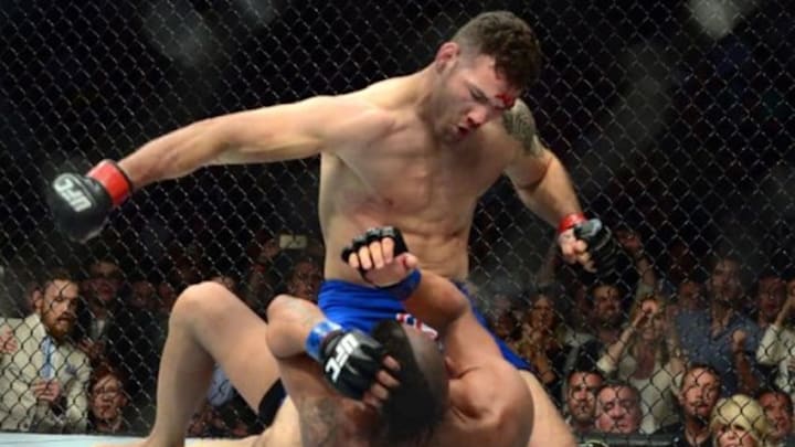 May 23, 2015; Las Vegas, NV, USA; Chris Wiedman (red gloves) and Vitor Belfort (blue gloves) fight during their middleweight championship bout during UFC 187 at MGM Grand Garden Arena. Weidman won via first round TKO. Mandatory Credit: Joe Camporeale-USA TODAY Sports