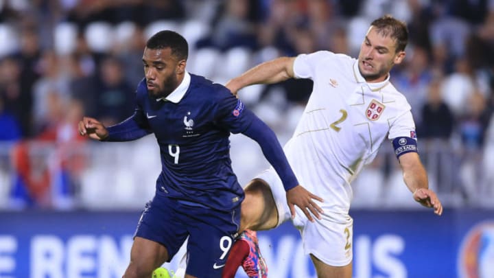 BELGRADE, SERBIA - SEPTEMBER 07: Alexandre Lacazette (L) of France is challenged by Branislav Ivanovic (R) of Serbia during the International friendly match between Serbia and France at the Stadium JNA on September 07, 2014 in Belgrade, Serbia, 2014. (Photo by Srdjan Stevanovic/Getty Images)