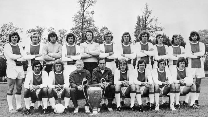 European Cup holders Ajax pose for a team photo with the trophy, 30th March 1973. Front row left to right, Sjaak Swart, Johnny Rep, coach Stephan Kovacs, trainer Bob Haarms, Ger Kleton, Jan Mulder, Johan Cruyff and Gerrie Muhren. Back row, left to right, Arie Haan, Horst Blankenburg, Sies Wever, Wim Suurbier, goalkeeper Heinz Stuy, Piet Keizer, Ruud Krol, Heinz Schilcher, Arnold Muhren, Johan Neeskens and Barry Hulshoff. (Photo by Central Press/Hulton Archive/Getty Images)