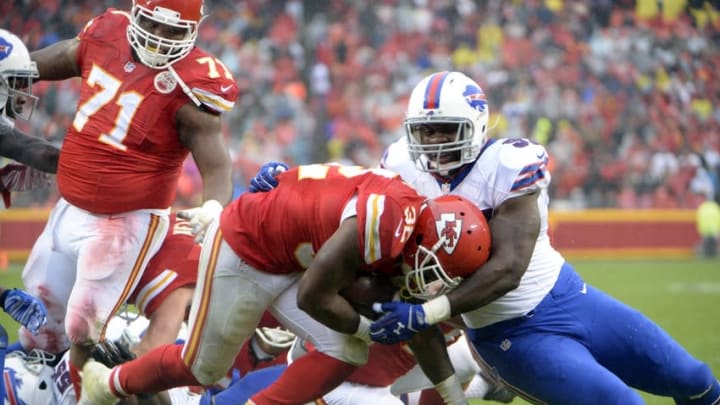 Nov 29, 2015; Kansas City, MO, USA; Kansas City Chiefs running back Spencer Ware (32) rushes for a touchdown against Buffalo Bills defensive tackle Corbin Bryant (97) in the first half at Arrowhead Stadium. Mandatory Credit: John Rieger-USA TODAY Sports