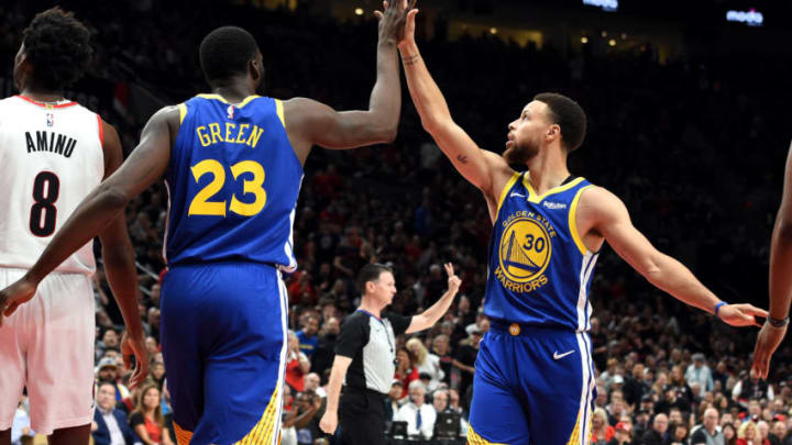 PORTLAND, OREGON - MAY 18: Stephen Curry #30 of the Golden State Warriors high fives Draymond Green #23 during the first half against the Portland Trail Blazers in game three of the NBA Western Conference Finals at Moda Center on May 18, 2019 in Portland, Oregon. NOTE TO USER: User expressly acknowledges and agrees that, by downloading and or using this photograph, User is consenting to the terms and conditions of the Getty Images License Agreement. (Photo by Steve Dykes/Getty Images)