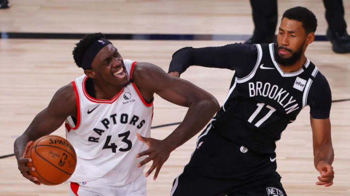 LAKE BUENA VISTA, FLORIDA - AUGUST 17: Pascal Siakam #43 of the Toronto Raptors drives against Garrett Temple #17 of the Brooklyn Nets and is charged with an offensive foul during the third quarter in Game One of the Eastern Conference First Round during the 2020 NBA Playoffs at AdventHealth Arena at ESPN Wide World Of Sports Complex on August 17, 2020 in Lake Buena Vista, Florida. (Photo by Kevin C. Cox/Getty Images)