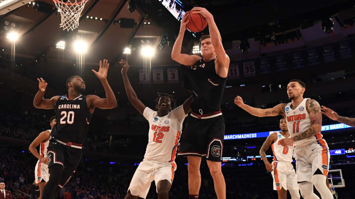 Mar 26, 2017; New York, NY, USA; South Carolina Gamecocks forward Maik Kotsar (21) grabs a rebound against Florida Gators forward Gorjok Gak (12) during the second half in the finals of the East Regional of the 2017 NCAA Tournament at Madison Square Garden. Mandatory Credit: Robert Deutsch-USA TODAY Sports