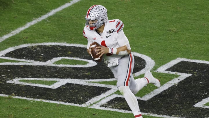 MIAMI GARDENS, FLORIDA – JANUARY 11: Justin Fields #1 of the Ohio State Buckeyes scrambles during the fourth quarter of the College Football Playoff National Championship game against the Alabama Crimson Tide at Hard Rock Stadium on January 11, 2021 in Miami Gardens, Florida. (Photo by Michael Reaves/Getty Images)