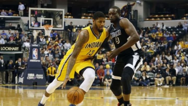 Dec 11, 2015; Indianapolis, IN, USA; Indiana Pacers forward Paul George (13) drives to the basket against Miami Heat forward Luol Deng (9) at Bankers Life Fieldhouse. Mandatory Credit: Brian Spurlock-USA TODAY Sports
