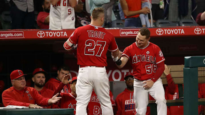 ANAHEIM, CA - SEPTEMBER 29: Mike Trout #27 of the Los Angeles Angels of Anaheim is congratulated by teammate Kole Calhoun #56 at the dugout entrance after Trout hit a solo homerun during the first inning of the MLB game against the Seattle Mariners at Angel Stadium of Anaheim on September 29, 2017 in Anaheim, California. (Photo by Victor Decolongon/Getty Images)