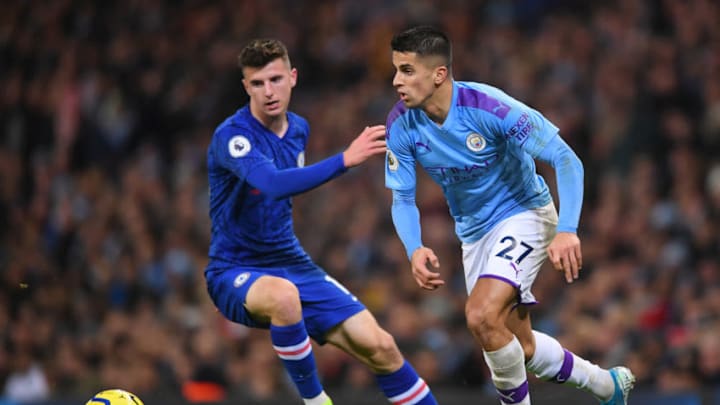 MANCHESTER, ENGLAND - NOVEMBER 23: Joao Cancelo of Manchester City runs past Mason Mount of Chelsea during the Premier League match between Manchester City and Chelsea FC at Etihad Stadium on November 23, 2019 in Manchester, United Kingdom. (Photo by Laurence Griffiths/Getty Images)