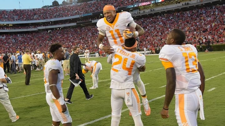 Oct 1, 2016; Athens, GA, USA; Tennessee Volunteers quarterback Joshua Dobbs (11) is lifted in the air by defensive back Todd Kelly Jr. (24) after throwing the winning touchdown pass on the last play on the game against the Georgia Bulldogs during the fourth quarter at Sanford Stadium. Tennessee defeated Georgia 34-31. Mandatory Credit: Dale Zanine-USA TODAY Sports