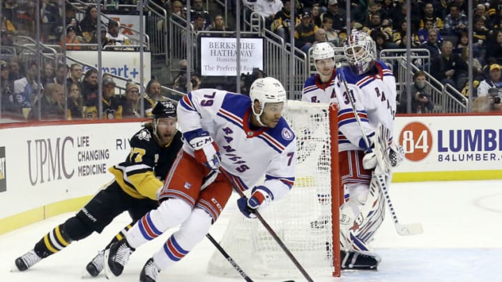 Feb 26, 2022; Pittsburgh, Pennsylvania, USA; New York Rangers defenseman K'Andre Miller (79) skates with the puck from behind the net as Pittsburgh Penguins center Jeff Carter (77) chases during the third period at PPG Paints Arena. The Penguins shutout the Rangers 1-0. Mandatory Credit: Charles LeClaire-USA TODAY Sports
