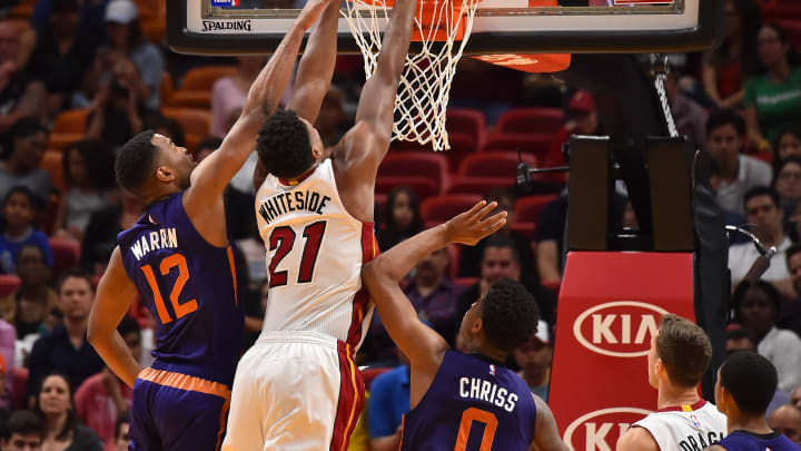 Mar 21, 2017; Miami, FL, USA; Miami Heat center Hassan Whiteside (21) dunks the ball over Phoenix Suns forward TJ Warren (12) during the second half at American Airlines Arena. The Miami Heat defeat the Phoenix Suns 112-97. Mandatory Credit: Jasen Vinlove-USA TODAY Sports