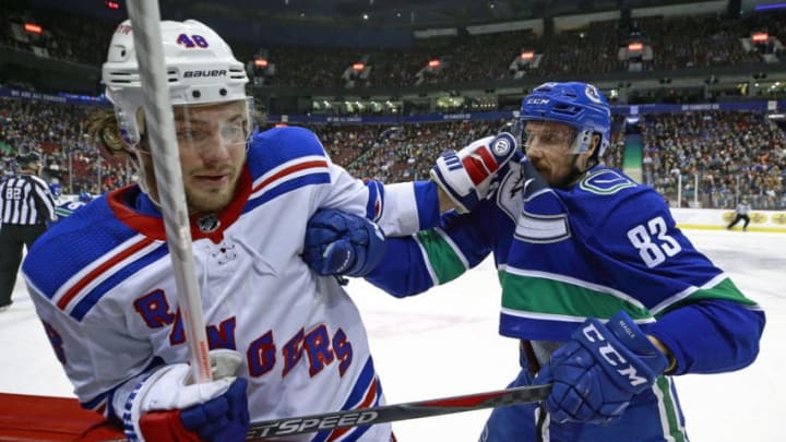 VANCOUVER, BC - MARCH 13: Jay Beagle #83 of the Vancouver Canucks checks Brendan Lemieux #48 of the New York Rangers during their NHL game at Rogers Arena March 13, 2019 in Vancouver, British Columbia, Canada. (Photo by Jeff Vinnick/NHLI via Getty Images)