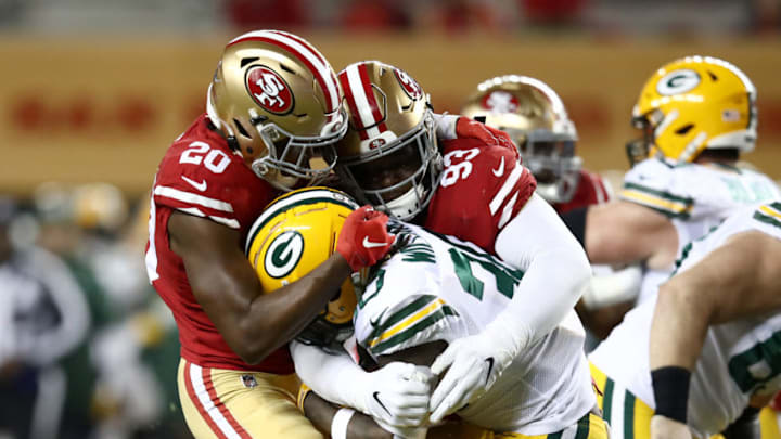 SANTA CLARA, CALIFORNIA - NOVEMBER 24: Jamaal Williams #30 of the Green Bay Packers is tackled by Jimmie Ward #20 and D.J. Jones #93 of the San Francisco 49ers at Levi's Stadium on November 24, 2019 in Santa Clara, California. (Photo by Ezra Shaw/Getty Images)