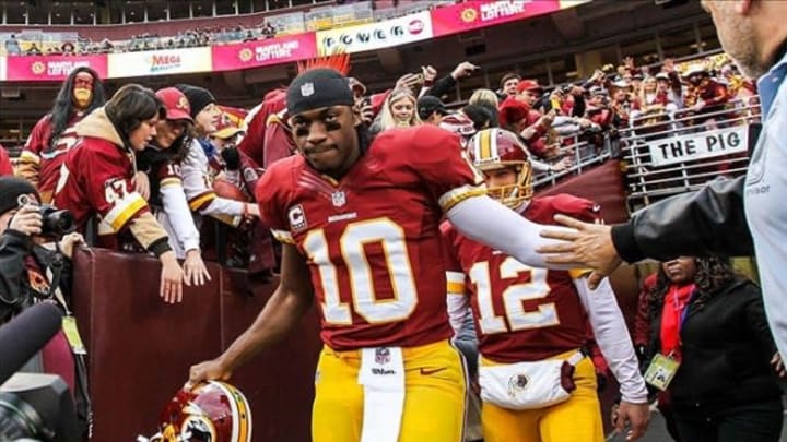 Jan 6, 2013; Landover, MD, USA; Washington Redskins quarterback Robert Griffin III (10) high fives fans as he comes out on the field before warm ups before the NFC Wild Card playoff game against the Seattle Seahawks at FedEx Field. Mandatory Credit: Daniel Shirey-USA TODAY Sports