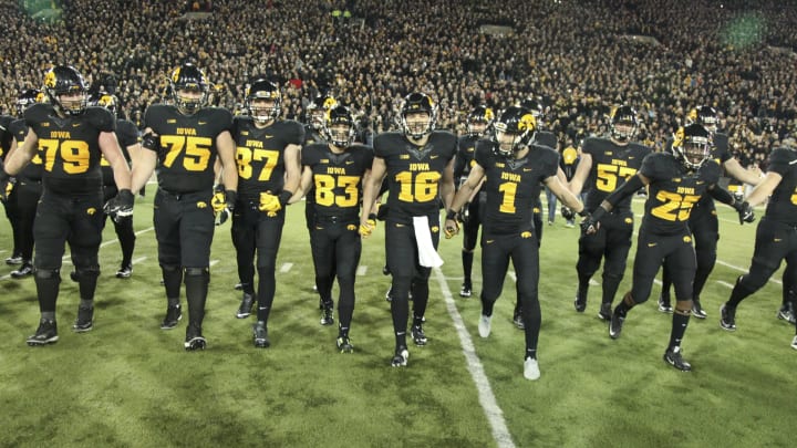 IOWA CITY, IA – NOVEMBER 14: Members of the Iowa Hawkeyes swarm the field to collect The Floyd of Rosedale trophy after defeating the Minnesota Gophers on November 14, 2015 at Kinnick Stadium, in Iowa City, Iowa. (Photo by Matthew Holst/Getty Images)