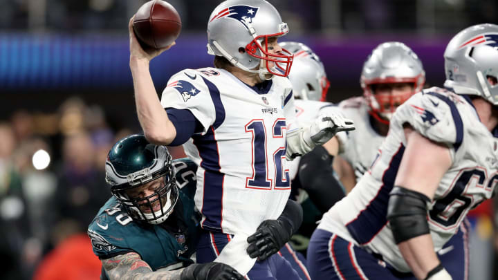 MINNEAPOLIS, MN – FEBRUARY 04: Tom Brady #12 of the New England Patriots attempts to throw a pass under pressure from Derek Barnett #96 of the Philadelphia Eagles during the fourth quarter in Super Bowl LII at U.S. Bank