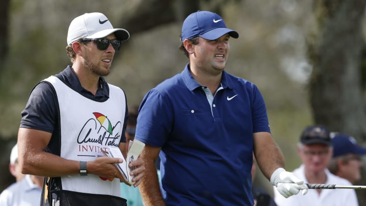 Mar 5, 2020; Orlando, Florida, USA; Patrick Reed (right) lines up his shot on the 11th hole with his caddie during the first round of the Arnold Palmer Invitational golf tournament at Bay Hill Club & Lodge. Mandatory Credit: Reinhold Matay-USA TODAY Sports