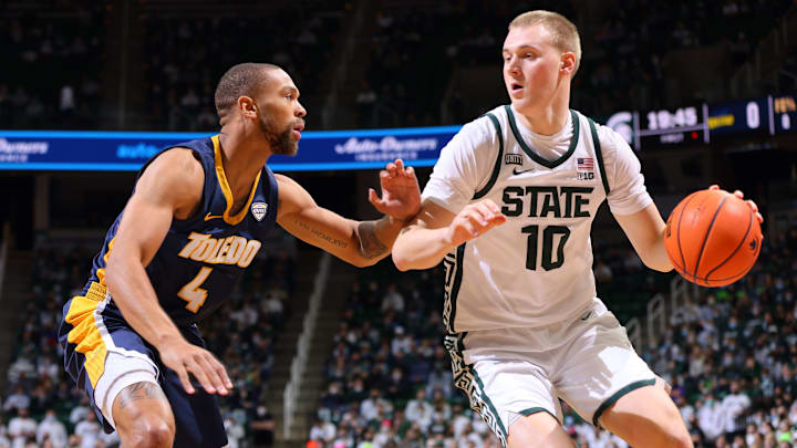 EAST LANSING, MI – DECEMBER 04: Joey Hauser #10 of the Michigan State Spartans handles the ball under pressure from Setric Millner Jr. #4 of the Toledo Rockets at Breslin Center on December 4, 2021 in East Lansing, Michigan. (Photo by Rey Del Rio/Getty Images)