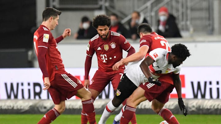 FC Bayern Munich players swarm the ball in their win over Stuttgart. (Photo by THOMAS KIENZLE/AFP via Getty Images)