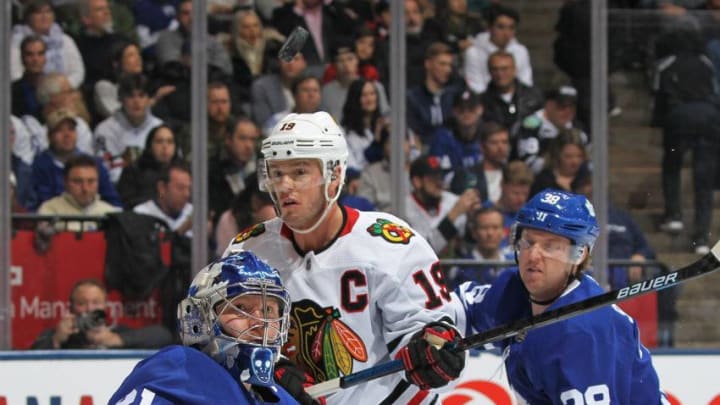Frederik Andersen #31 of the Toronto Maple Leafs keeps an eye on a puck with Jonathan Toews #19 of the Chicago Blackhawks on his doorstep during an NHL game at Scotiabank Arena. (Photo by Claus Andersen/Getty Images)