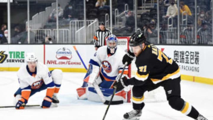 Apr 16, 2021; Boston, Massachusetts, USA; Boston Bruins left wing Taylor Hall (71) controls the puck in front of New York Islanders goaltender Ilya Sorokin (30) while defenseman Scott Mayfield (24) defends during the second period at TD Garden. Mandatory Credit: Bob DeChiara-USA TODAY Sports