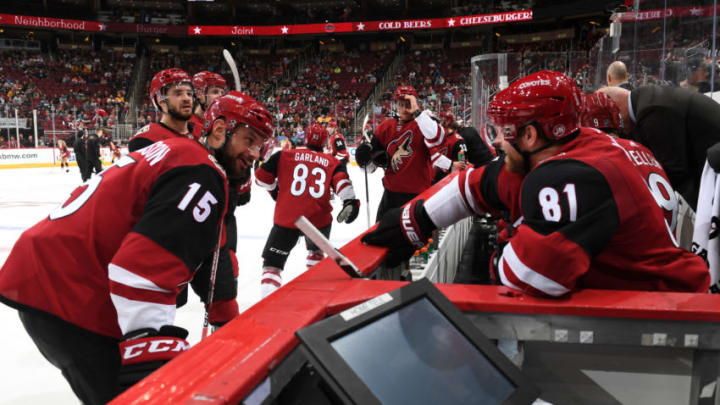 GLENDALE, ARIZONA - OCTOBER 17: Phil Kessel #81 of the Arizona Coyotes talks with Brad Richardson #15 while sitting on the bench during a stop in play against the Nashville Predators at Gila River Arena on October 17, 2019 in Glendale, Arizona. (Photo by Norm Hall/NHLI via Getty Images)