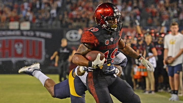 Sep 10, 2016; San Diego, CA, USA; San Diego State Aztecs running back Donnel Pumphrey (19) scores a touchdown as California Golden Bears cornerback Darius Allensworth (2) defends during the fourth quarterat Qualcomm Stadium. Mandatory Credit: Jake Roth-USA TODAY Sports