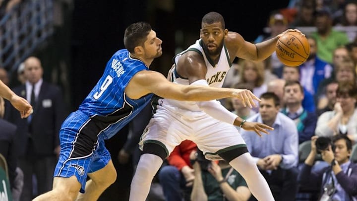 Apr 1, 2016; Milwaukee, WI, USA; Milwaukee Bucks center Greg Monroe (15) dribbles the ball as Orlando Magic center Nikola Vucevic (9) reaches in during the first quarter at BMO Harris Bradley Center. Mandatory Credit: Jeff Hanisch-USA TODAY Sports