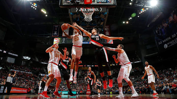 ATLANTA, GA - DECEMBER 30: John Collins #20 of the Atlanta Hawks grabs a rebound against Zach Collins #33 of the Portland Trail Blazers at Philips Arena on December 30, 2017 in Atlanta, Georgia. NOTE TO USER: User expressly acknowledges and agrees that, by downloading and or using this photograph, User is consenting to the terms and conditions of the Getty Images License Agreement. (Photo by Kevin C. Cox/Getty Images)